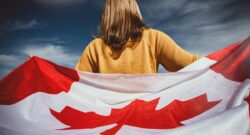 A girl holding the Canadian flag