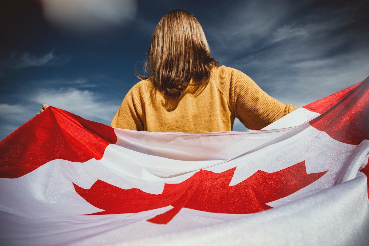 A girl holding the Canadian flag