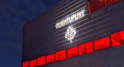 A building with red lights, and the LightUpLive logo